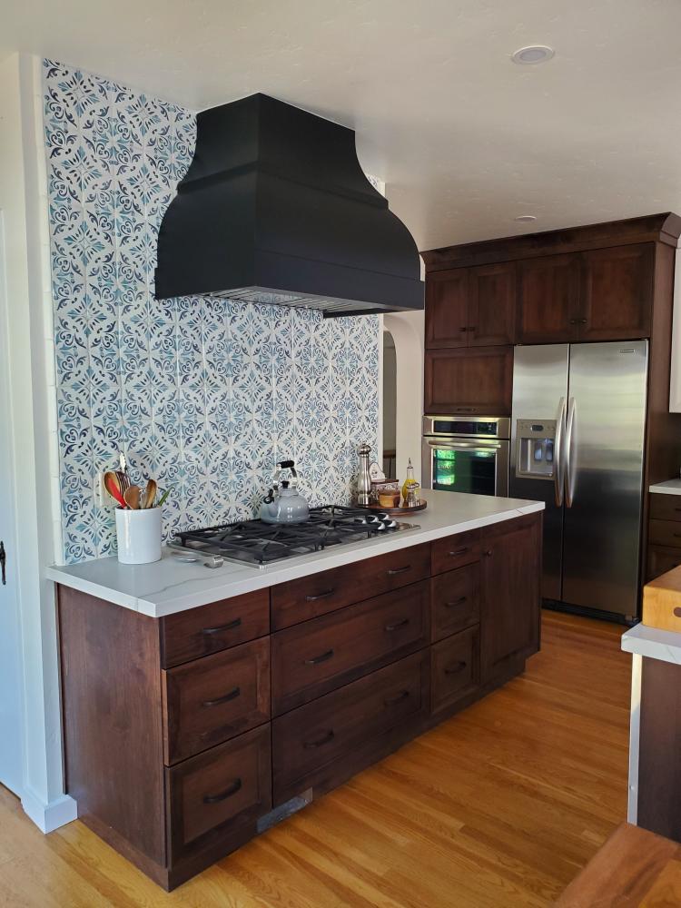 brown cabinets and black kitchen range hood