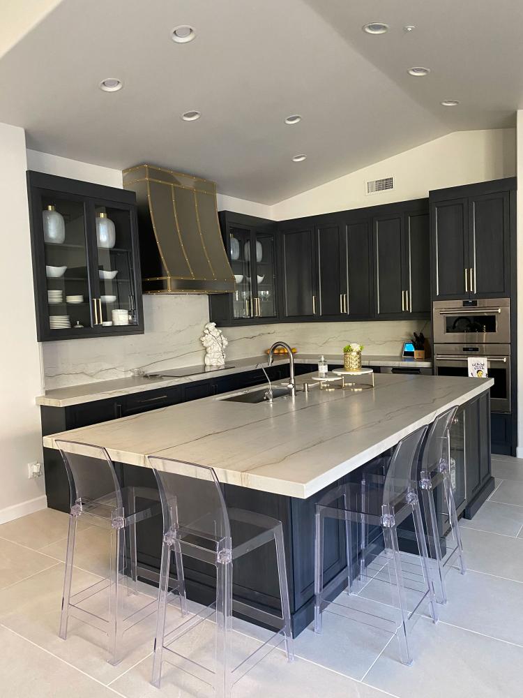 black cabinets with stainless steel range hood