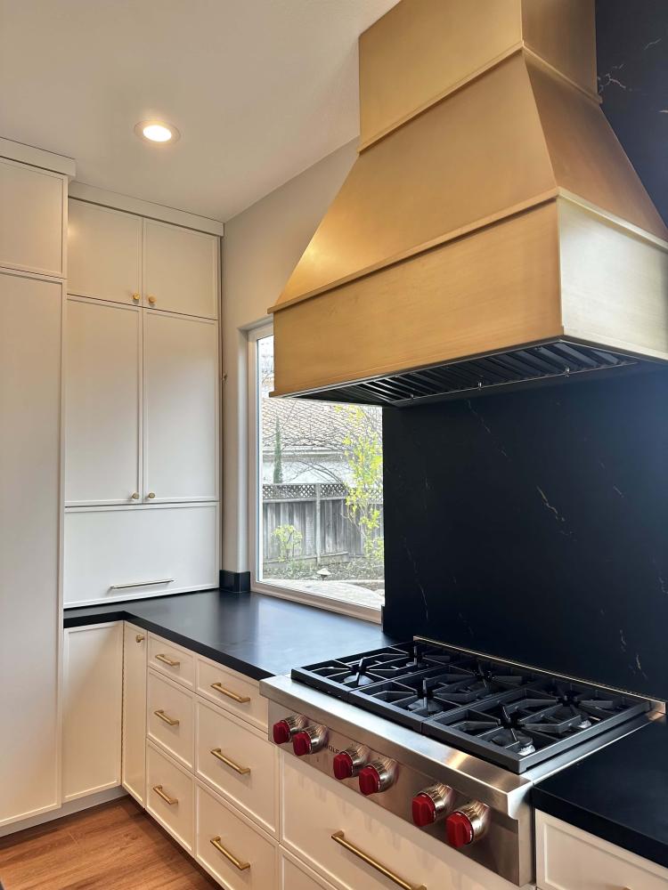 french kitchen design with brass range hood