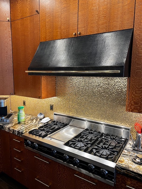 metal backsplash with beautiful lighting